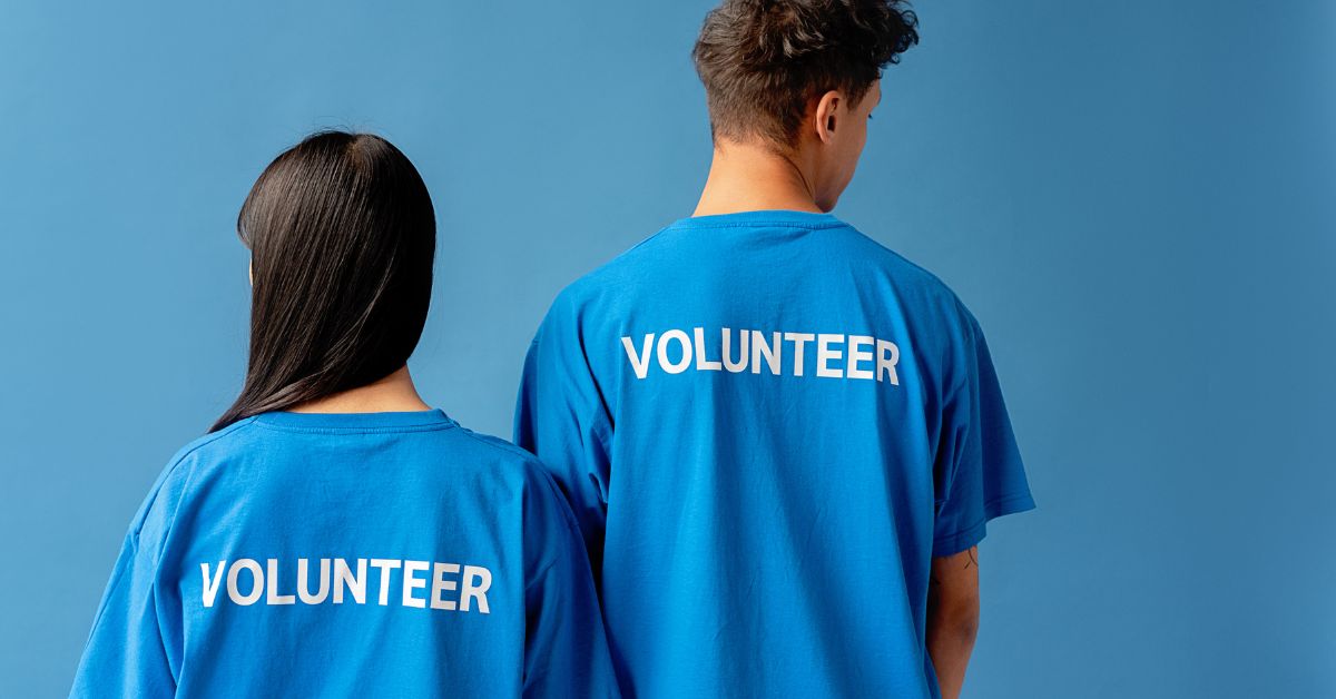 Young Couple Wearing Blue Shirts with White Sublimation Text