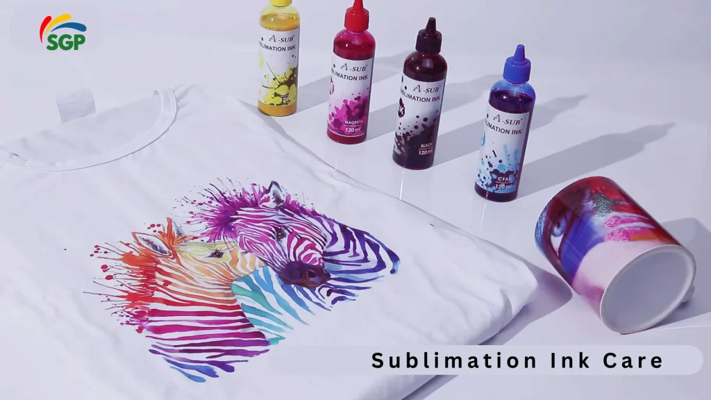 A white T-shirt with a vibrant, multicolored zebra design printed using sublimation ink. Surrounding the T-shirt are four bottles of A-Sub sublimation ink in cyan, magenta, yellow, and black colors, along with a colorful mug showcasing another sublimation print.