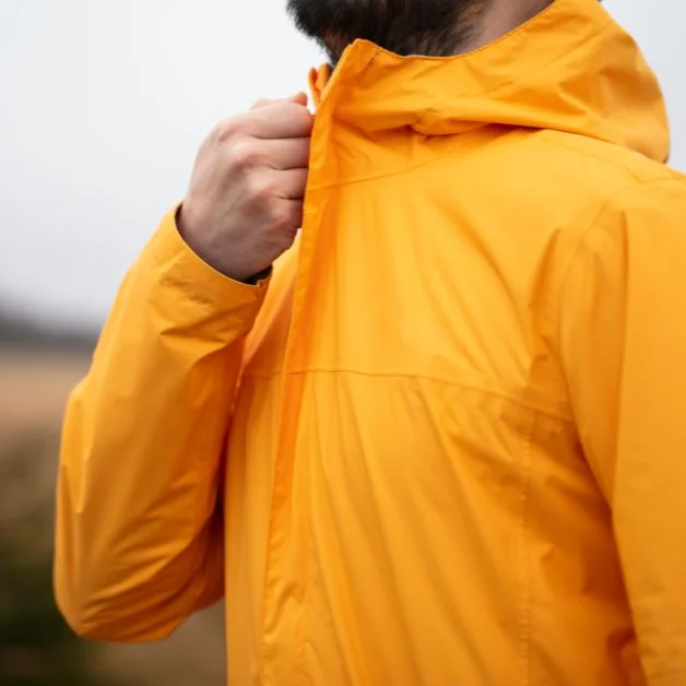 A man wear orange color jacket of POLYESTER-RAYON BLENDS.