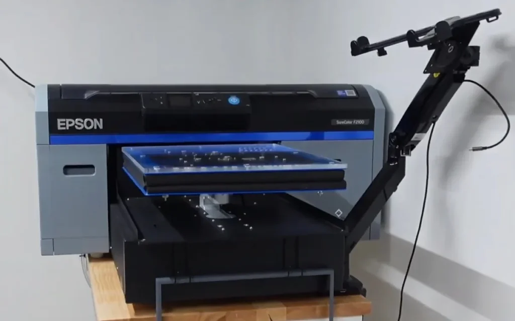 A black Epson SureColor F2100 sublimation printer.