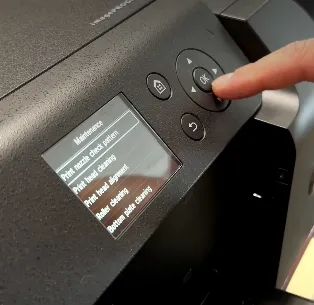 A person adjusting the printer banding setting.